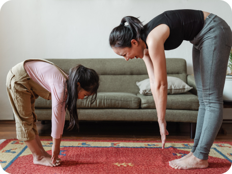 Mother and daughter excercising and stretching together
