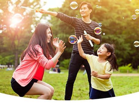 Woman playing with her daughter and throwing her into the air